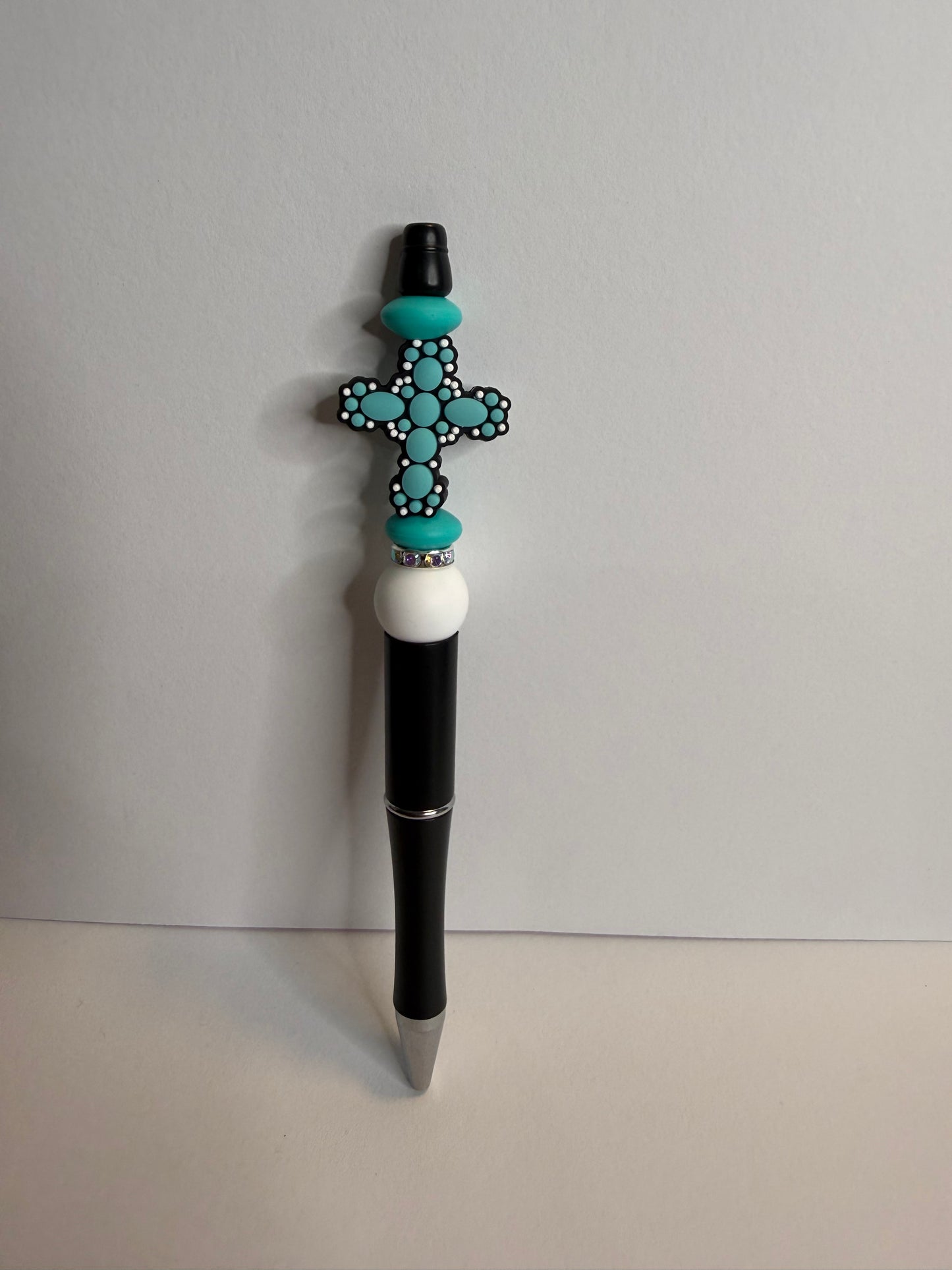 teal cross on black premade pen